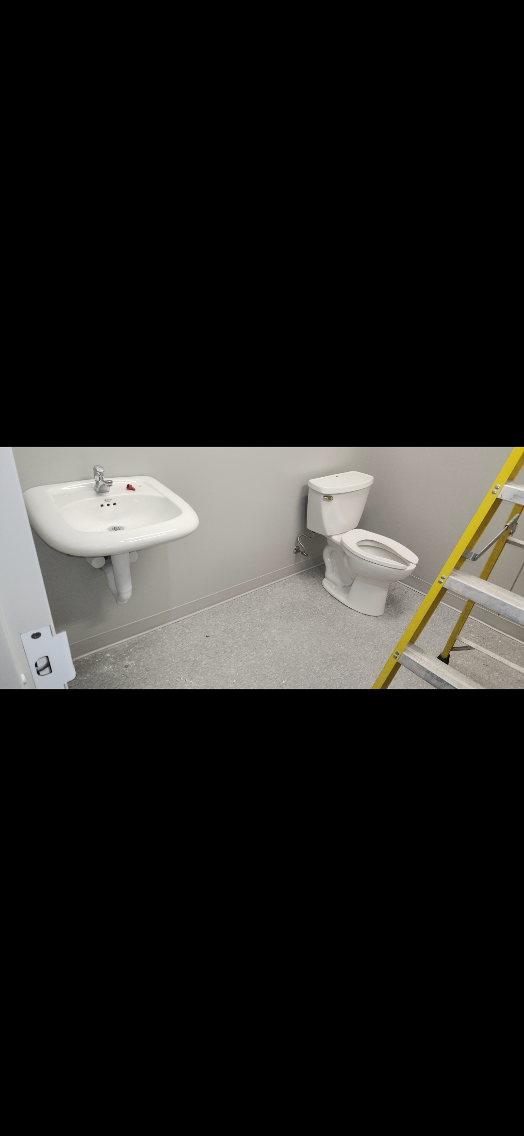 Completed bathroom with pedestal sink and toilet installation